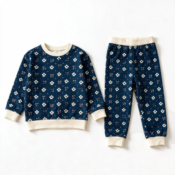 JOWI Blue Ditsy Pajama Set shown flat from the front, cream ditsy floral on navy, cream ribbing