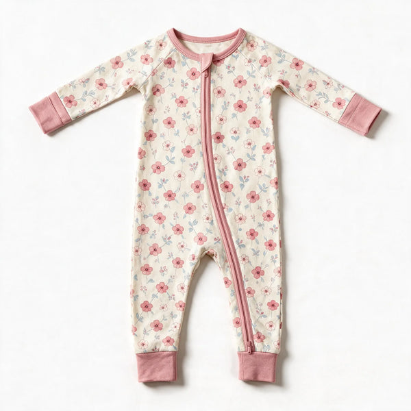 JOWI Blush Floral Romper shown flat from the front, small blush floral on cream, dusty pink trims