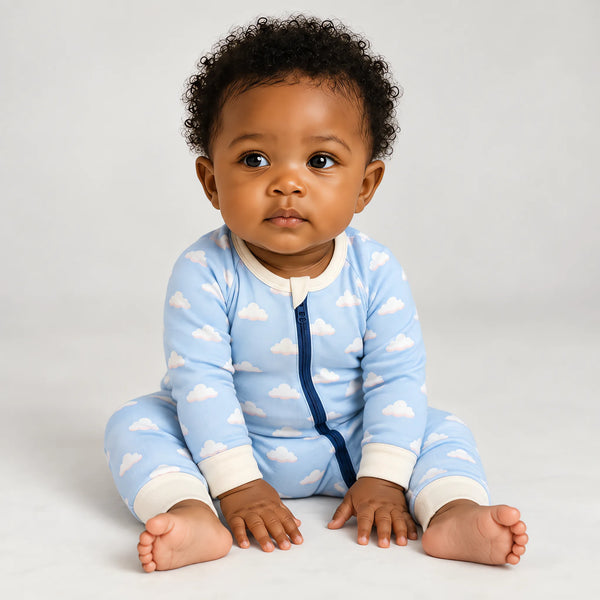 A baby wearing the JOWI Cozy Cloud Sleepsuit on a plain studio background, full body