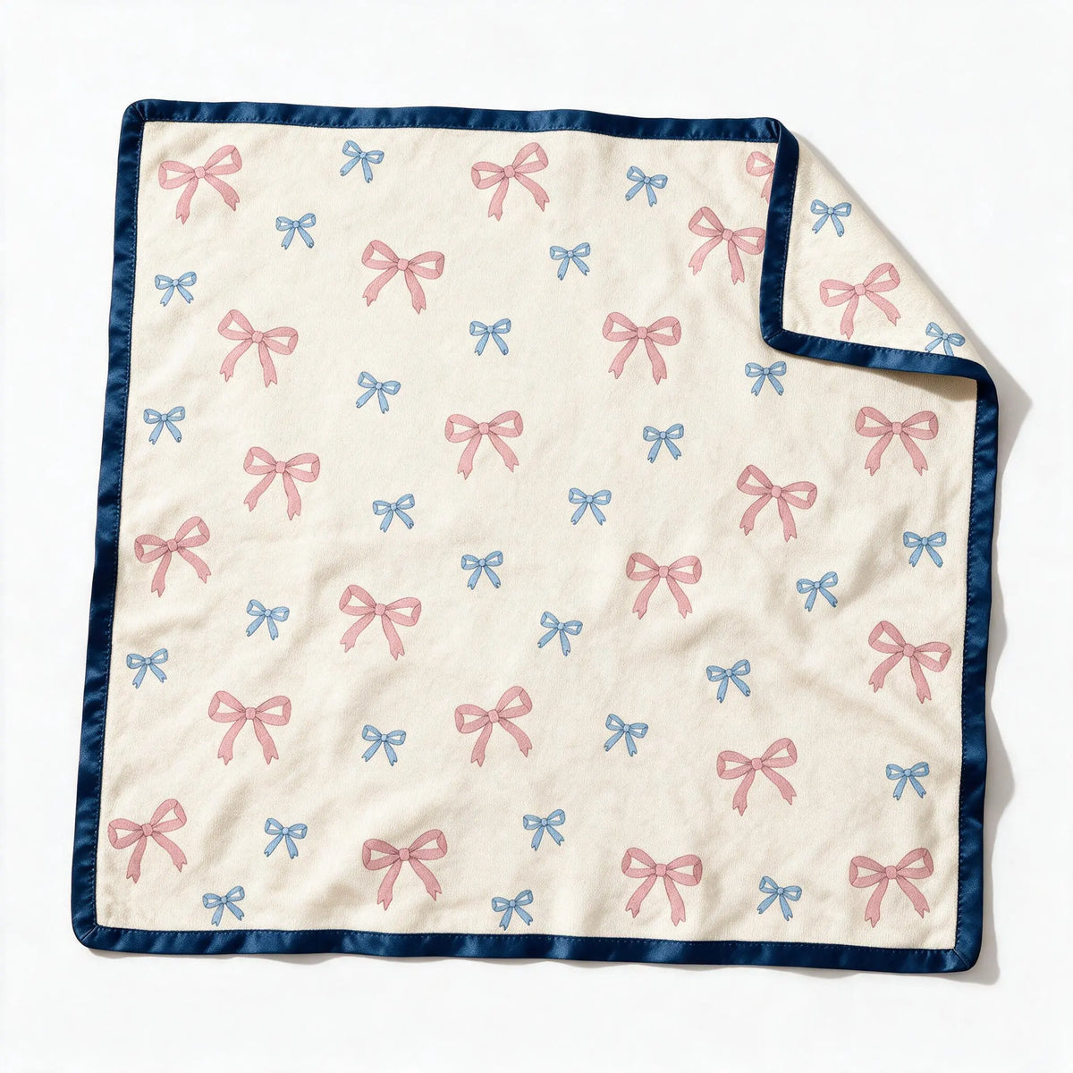 JOWI Baby Blanket shown flat from the front, cream ground, small scattered bows, navy satin binding