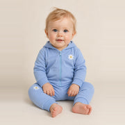 Toddler girl sitting in the JOWI Blue Daisy Hoodie & Jogger Set, size 12-24 months