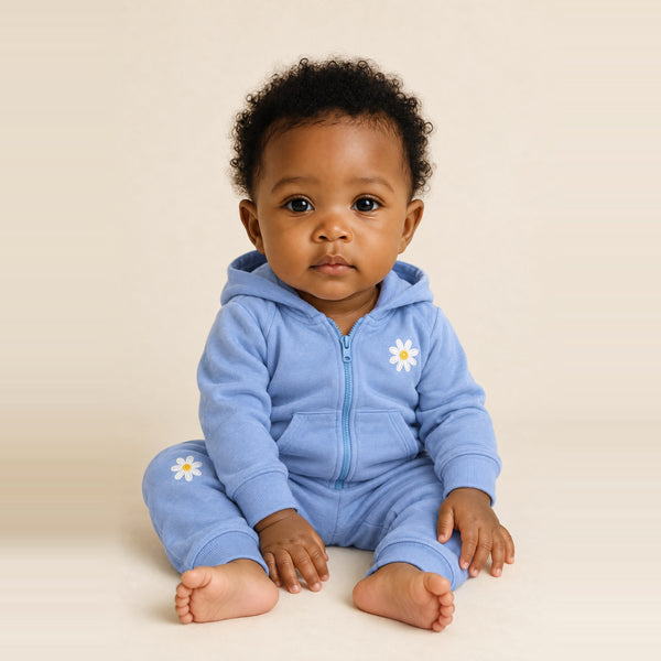 Baby girl sitting in the JOWI Blue Daisy Hoodie & Jogger Set, size 6-12 months