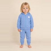 Little girl standing in the JOWI Blue Daisy Hoodie & Jogger Set, size 2T-3T