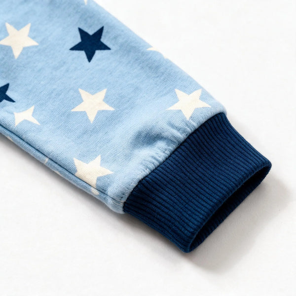 Close up photograph of the JOWI Blue Star Dream Set on white: the plain navy ribbed cuff, gathered where the star print is eased into it