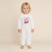 Little girl standing in the JOWI Cherry Bow Sweatshirt & Jogger Set, size 2T-3T