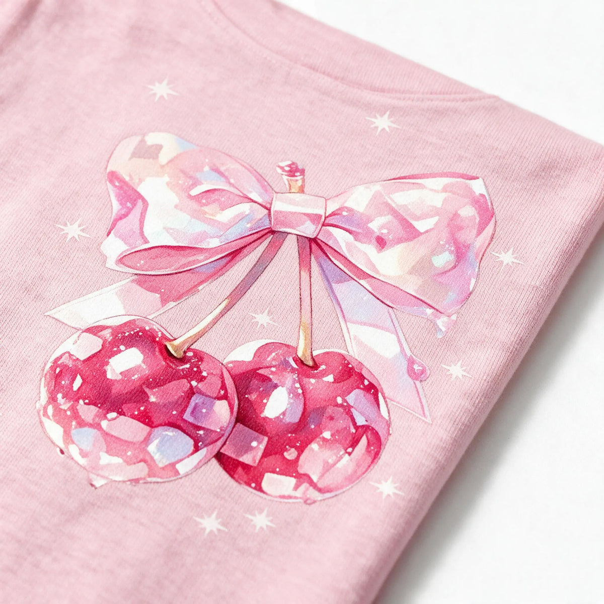 Close up photograph of the bow tied over two cherries on the chest of the JOWI Cherry Bow Tee & Short Set, with the cotton jersey at true scale