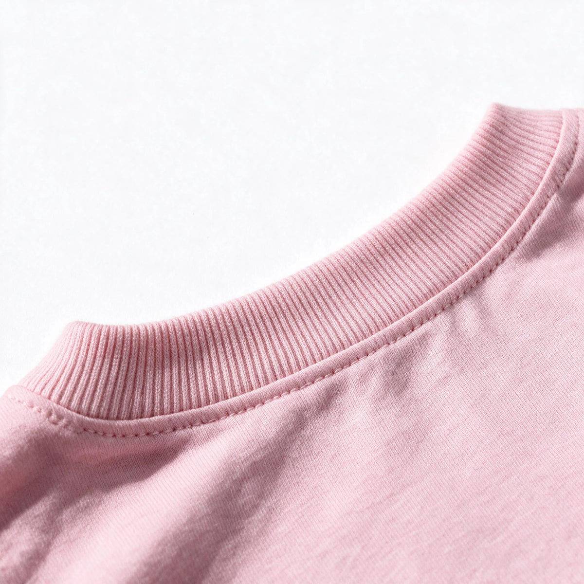 Close up photograph of the JOWI Cherry Bow Tee & Short Set on white: the ribbed crew neckband and the seam joining it to the body of the tee