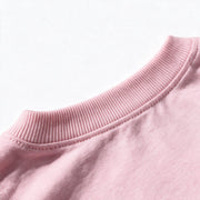 Close up photograph of the JOWI Cherry Bow Tee & Short Set on white: the ribbed crew neckband and the seam joining it to the body of the tee