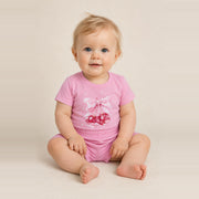 Toddler girl sitting in the JOWI Cherry Bow Tee & Short Set, size 12-24 months