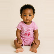 Baby girl sitting in the JOWI Cherry Bow Tee & Short Set, size 6-12 months