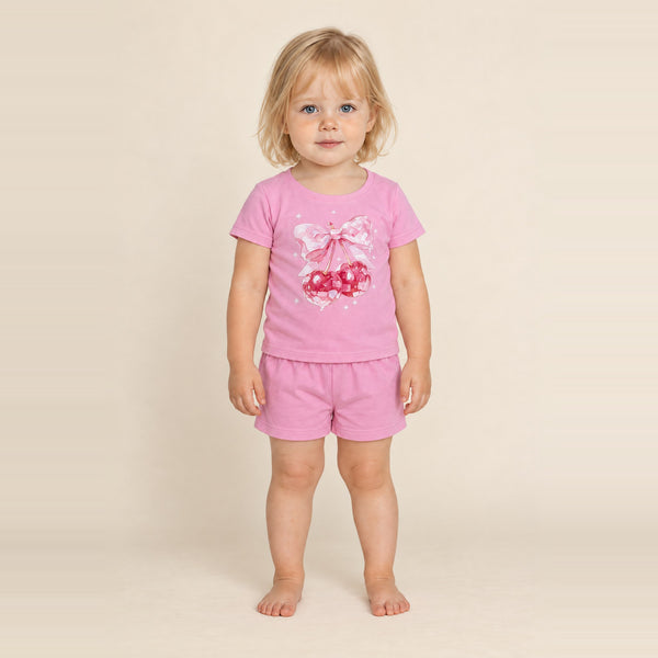 Little girl standing in the JOWI Cherry Bow Tee & Short Set, size 2T-3T