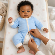 The JOWI Cloud Blue Baby Romper in use, showing the detail that makes it easy to put on and take off