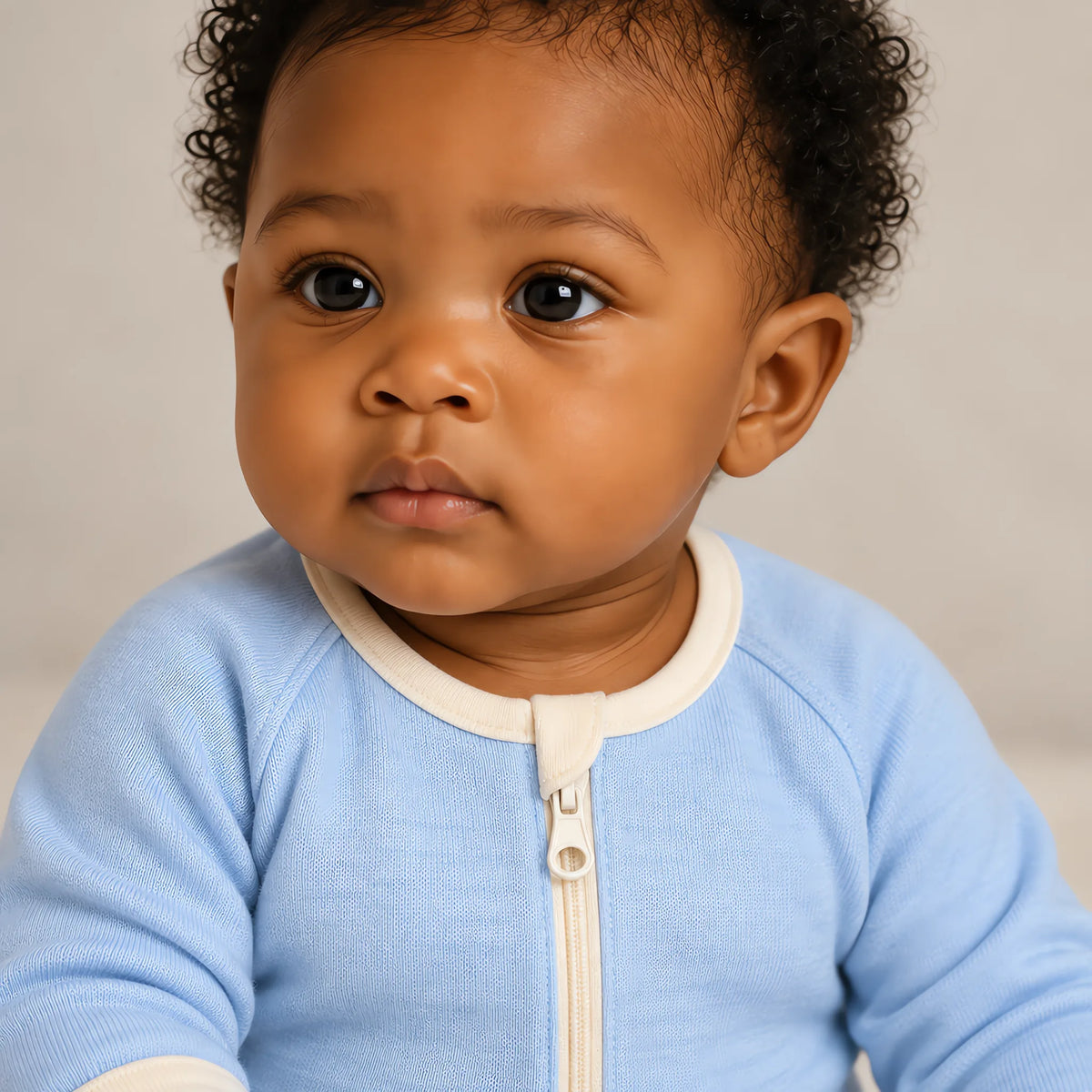 Close up of the JOWI Cloud Blue Baby Romper worn, with the printed cloth at true scale