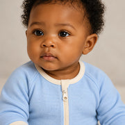 Close up of the JOWI Cloud Blue Baby Romper worn, with the printed cloth at true scale