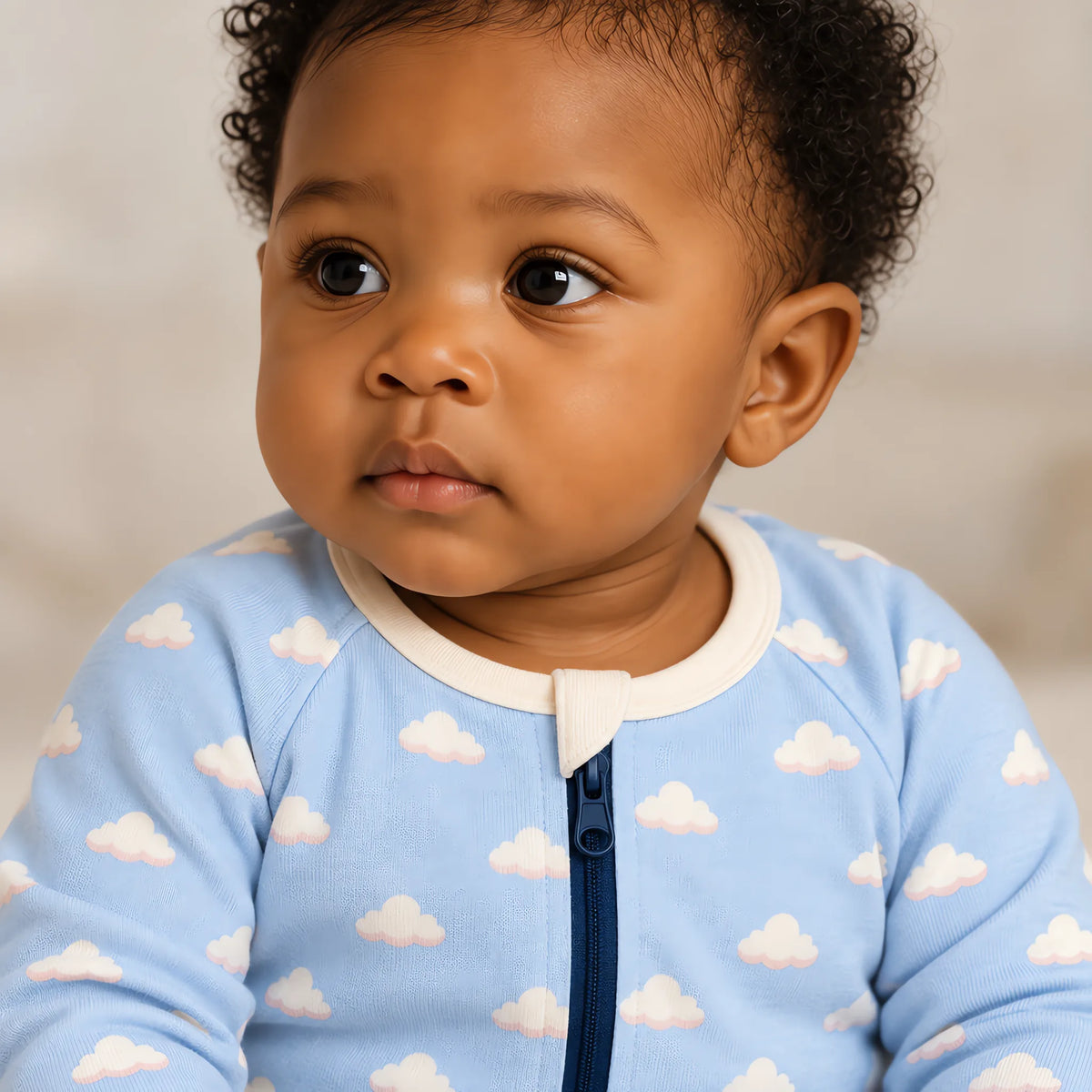 Close up of the JOWI Cozy Cloud Sleepsuit worn, with the printed cloth at true scale