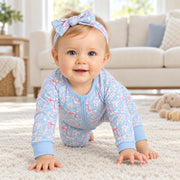 Baby crawling in the blue rose toile zip romper with the plain blue ankle cuffs in view