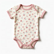 JOWI Soft Blossom Bodysuit shown flat from the front, small blossoms on cream, dusty pink trims, short sleeve