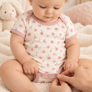 The JOWI Soft Blossom Bodysuit in use, showing the detail that makes it easy to put on and take off